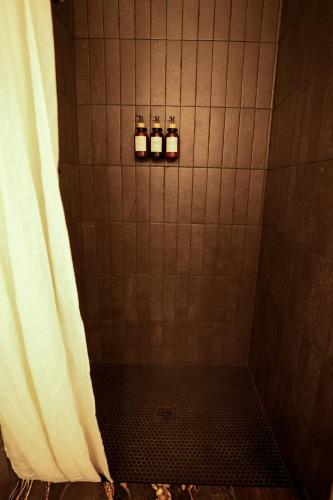 a shower with two bottles in a tiled bathroom at Ranch at Mesa Verde in Cortez