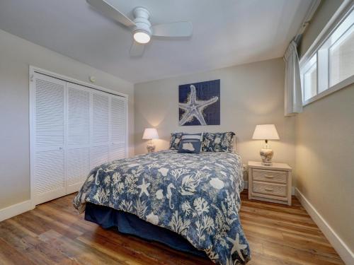 a bedroom with a bed and two lamps and a window at On the Beach Beachfront Condo Direct View & Access to Beach Heated Pool Island House Condominiums Unit 113 in Padre Island