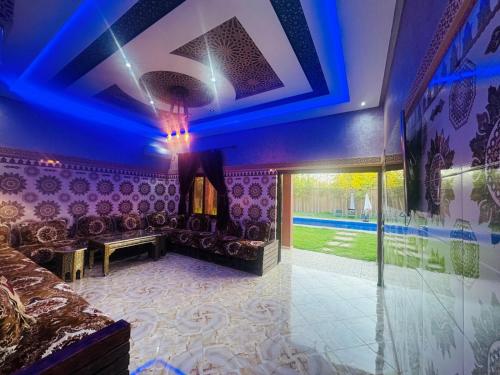 a room with a couch and a ceiling with blue lights at Villa Salah in Marrakech
