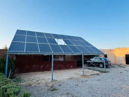 a car parked in front of a house with solar panels at Villa Salah in Marrakech