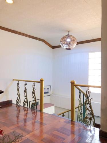 a living room with a staircase and a pendant light at Moradok Thai Guesthouse in Phra Nakhon Si Ayutthaya