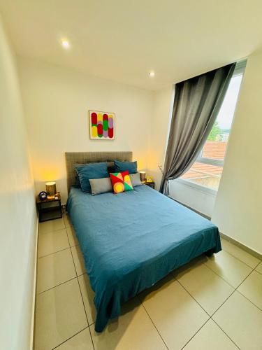 une chambre avec un lit bleu avec une fenêtre dans l'établissement LOFT DESIGN DUPLEX 2 CHAMBRES TERRASSE 20M2, à Marseille