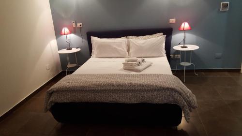 a bedroom with a large bed with two lamps at Hotel Ascot in Caianello