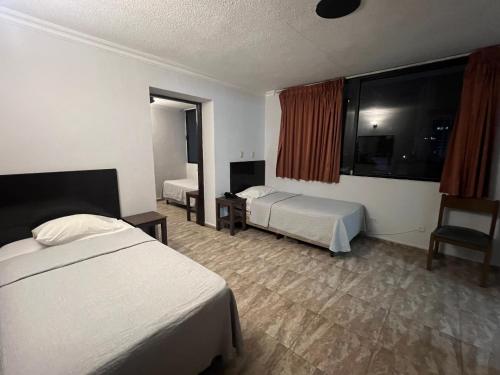 a hotel room with two beds and a tv at Eurohotel in Panama City