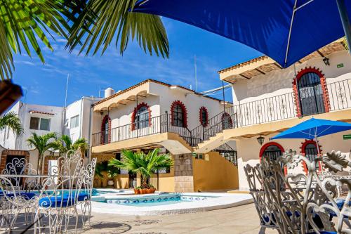 a view of a house with a swimming pool at Bungalows Maria Teresa in Rincon de Guayabitos