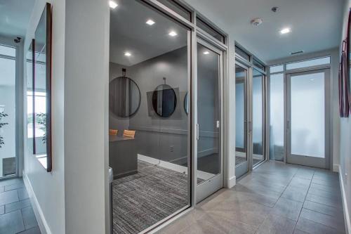 a bathroom with glass doors and a walk in shower at Ft Worth 1BR Luxury Retreat in Fort Worth