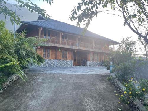 une grande maison en bois avec une grande cour dans l'établissement Homestay Bethel, à Sa Pả