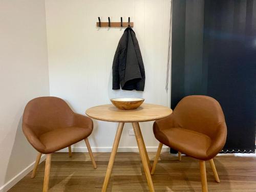 a table with two chairs and a bowl on it at Creswick Holiday Park in Creswick