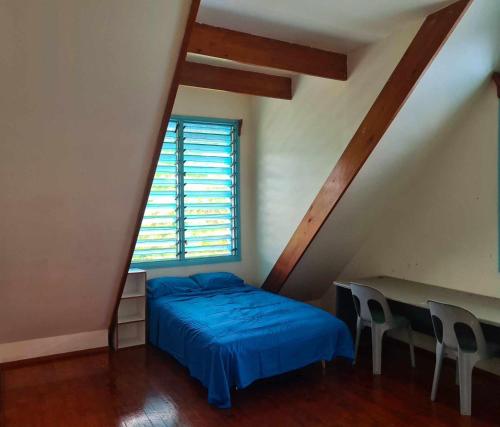 Tempat tidur dalam kamar di USO Homestay Samoa