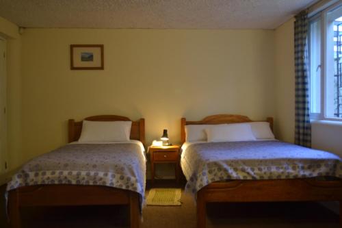 Postel nebo postele na pokoji v ubytování Travellers Inn