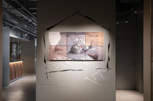 a wall in a room with a picture of a cat at KAIKA Tokyo by THE SHARE HOTELS in Tokyo