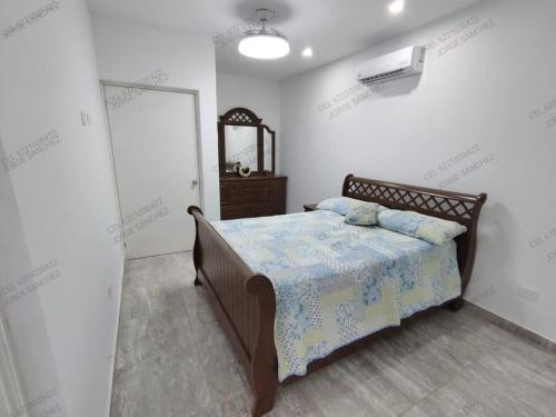 a bedroom with a bed and a mirror on the wall at Casa Cosmos 'Alberca Privada' in San Carlos