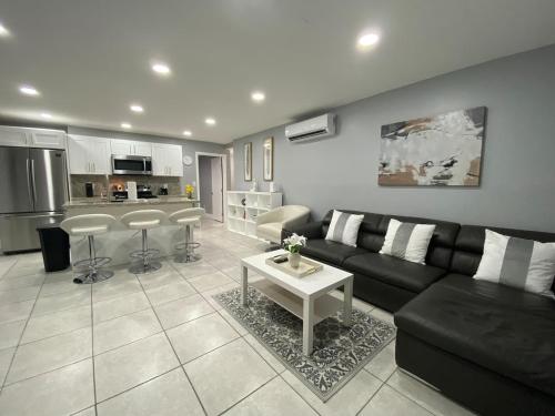 a living room with a black couch and a table at Executive Luxury Suite in Fort Lauderdale