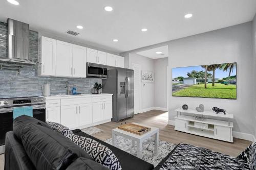 a kitchen and a living room with a couch and a table at The Front Wave Luxury Home in Fort Lauderdale