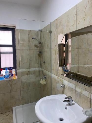 a bathroom with a sink and a shower at apartment in the city center in Durrës