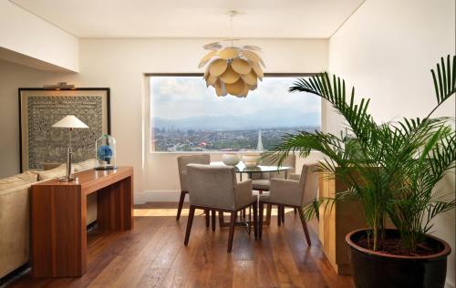 a dining room with a table and chairs and a window at Presidente InterContinental Mexico City by IHG in Mexico City