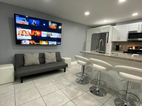 a living room with a couch and a tv at Executive Luxury Suite in Fort Lauderdale