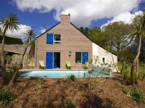 a house with a swimming pool in front of it at Évasion en Gîte de Charme avec Jardin, Piscine Chauffée et Proche Plages – Saint-Lyphard - FR-1-306-1271 in Saint-Lyphard