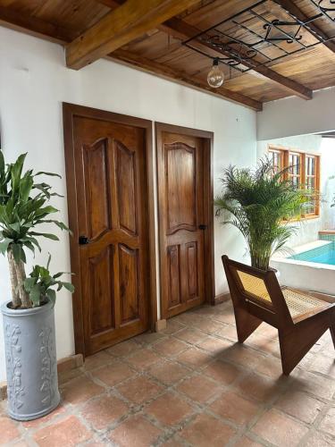 an entrance to a house with a wooden door at AptoPardo1945 duplex con Jacuzzi in Mompos