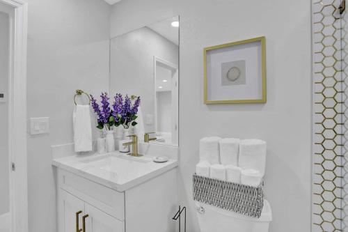 a white bathroom with a sink and a mirror at Yehudas Tropical Villa with Heated Infinity Pool in Hollywood
