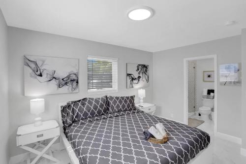 a bedroom with a bed in a white room at Yehudas Tropical Villa with Heated Infinity Pool in Hollywood