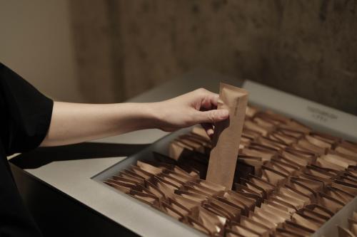 a person holding a piece of paper on a keyboard at MIROKU NARA by THE SHARE HOTELS in Nara