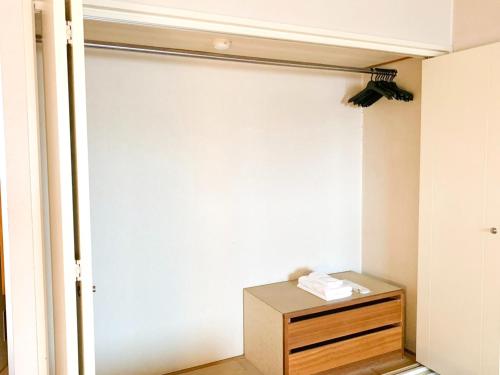 a room with a closet with a wooden dresser at Hotel Royal Kitami - Vacation STAY 04905v in Kitami