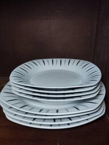 a stack of white plates sitting on a table at Suite acogedora en Ibarra in Ibarra