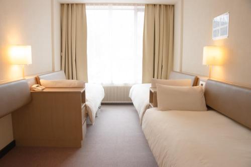 Postel nebo postele na pokoji v ubytování Shigakogen Prince Hotel