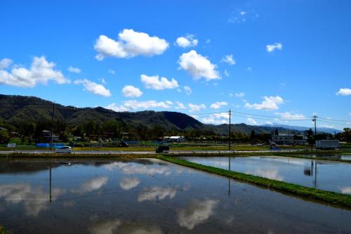a large body of water with clouds in the sky at Sasamori House in Azumino