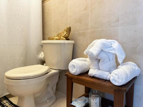 a bathroom with a toilet and towels on a table at Ocean Luxe in Paradise - Le Paradis Royal in Rincon