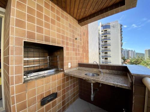 a bathroom with a sink in a brick wall at Riviera de Sao Lourenço in Bertioga