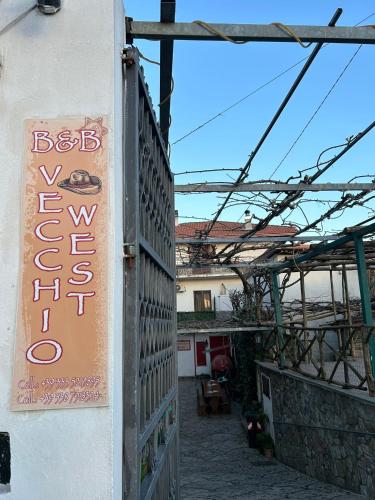 a sign for a restaurant on the side of a building at vecchio west in Agerola