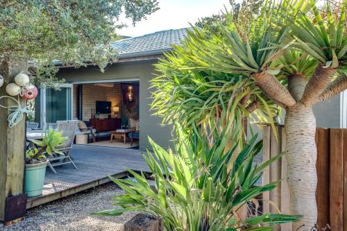 a home with palm trees and plants in the yard at Little Chill 4 Rosetta Tce Port Elliot - No Linen Included in Port Elliot