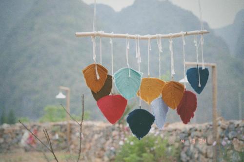 a bunch of colorful umbrellas hanging from a pole at Maison de Hill Home in Dồng Văn