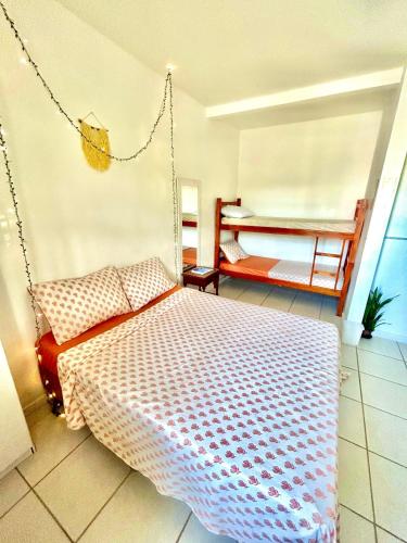 a bedroom with a swing bed and a balcony at Pequi hostel in Florianópolis