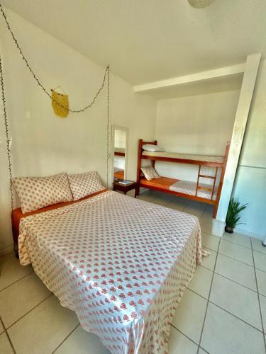 a bedroom with a bed and a swing at Pequi hostel in Florianópolis