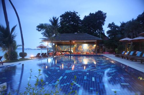 a swimming pool at a resort at night at Palm Coco Mantra in Lamai