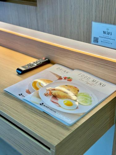 a book with a picture of eggs and fruit on it at Air Diamond Hotel in Ban Nong Khong
