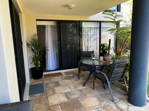 a balcony with a table and chairs on a patio at Eleven - Oceanside Retreat Busselton in Broadwater
