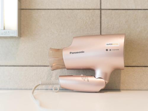 a hair dryer in a box on a counter at Super Hotel Premier JR Nara Eki in Nara