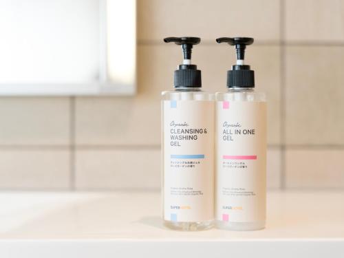 two bottles of cleaning products sitting next to each other at Super Hotel Premier JR Nara Eki in Nara