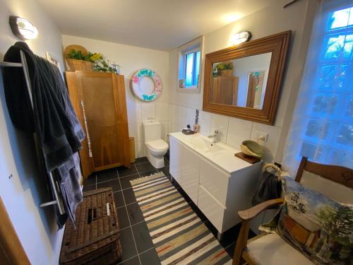 a bathroom with a sink and a toilet and a mirror at NOFOMO AT ADVENTURE BAY in Adventure Bay