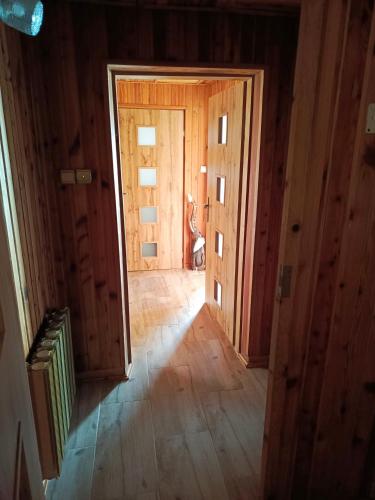 an empty hallway with a door in a house at Noclegi u Ewusi 2 in Januszowice