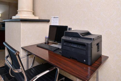 a desk with a printer and a computer on it at Holiday Inn Express Hotel & Suites El Centro by IHG in El Centro