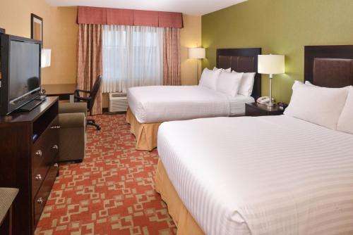 a hotel room with two beds and a flat screen tv at Holiday Inn Express Hotel & Suites El Centro by IHG in El Centro