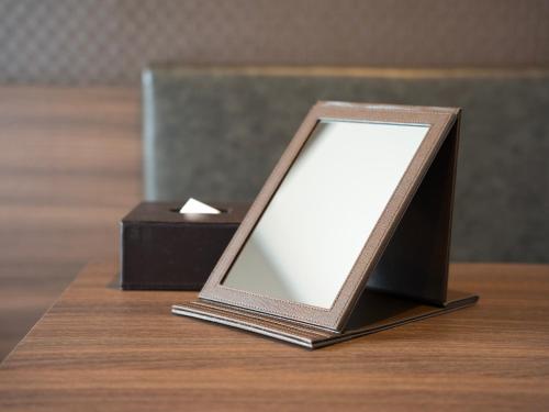 a picture frame sitting on top of a wooden table at Super Hotel Premier JR Nara Eki in Nara