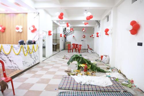 a room with a checkered floor and red balloons at Hotel A R S in Patna