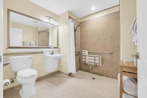 a bathroom with a toilet and a sink and a shower at K and J Orlando in Orlando