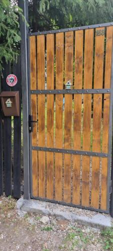 a wooden fence with a gate in a yard at OLD SHEPHERD Guest House in Râșca